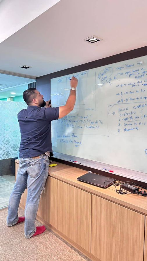 Jayden mapping out a content strategy on a whiteboard